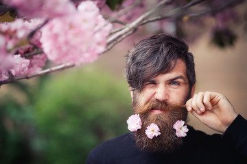 brutal bearded man brunette in a black blouse with elegant mustache and graying hair near the...