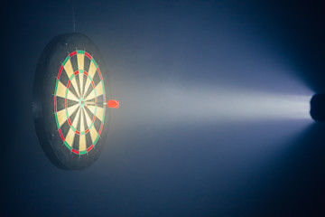 darts board illuminated with a spotlight