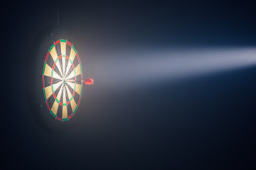 darts board illuminated with a spotlight