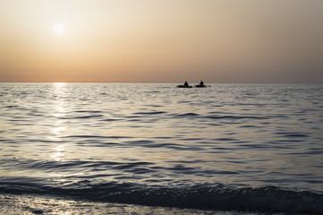 Fototapeta premium Beautiful sunrise over the sea, sun road, fishermen