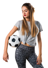 Woman player holding a soccer ball