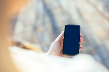 Close up of women's hands holding cell telephone with blank copy