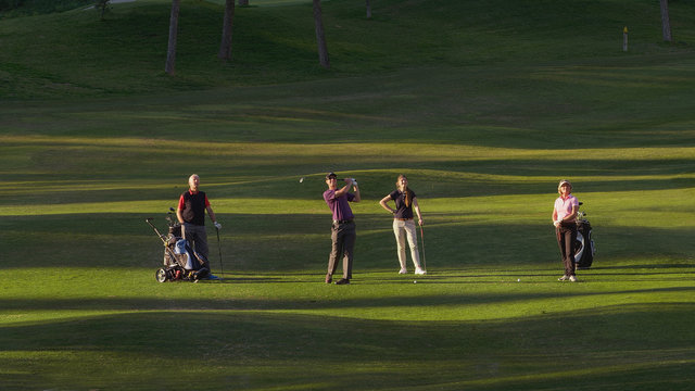 Family playing on a golf course