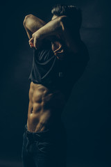 Undressing young man