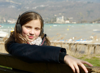 a young teenager listening to music on his phone