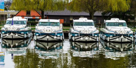 Fototapeta na wymiar Little yacht sailing on Marne-Rhin canal in Saverne, France