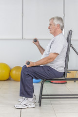 A senior man working out at a rehab centre