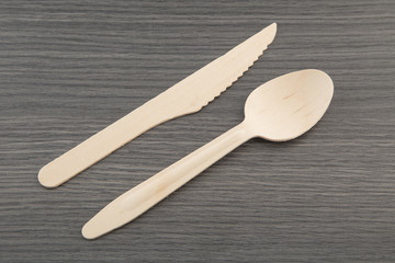 Wooden spoon and knife on wooden background