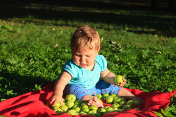 little girl picking apples in the garden