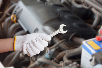 Hand of auto mechanic with wrench