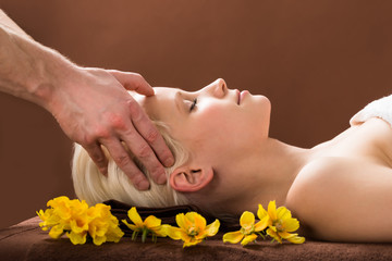 Obraz na płótnie Canvas Young Woman Receiving Massage At Spa