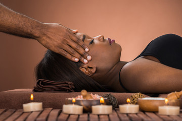 Obraz na płótnie Canvas Woman Receiving Forehead Massage In Spa