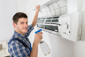 Male Technician Cleaning Air Conditioner