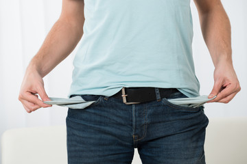Young Man Showing Empty Pockets