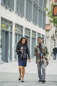 Couple walking on city sidewalk