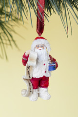 view of a santa christmas bauble hanging on christmas tree.