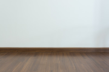 empty room, white mortar wall background and wood laminate floor