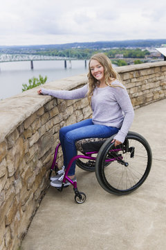 Caucasian disabled girl in wheelchair overlooking Columbus cityscape, Ohio, United States