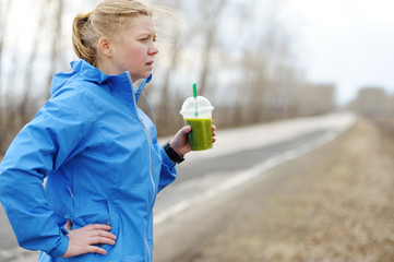 Green detox smoothie cup and woman