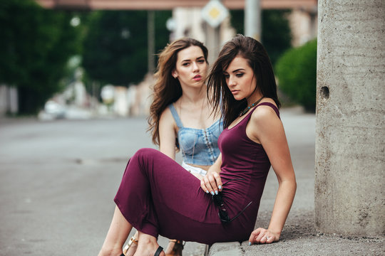 Two beautiful young girls posing in the city