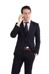 A young caucasian male businessman looking unhappy holding a mobile phone looking away from camera.