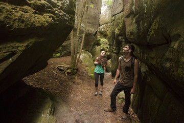 Caucasian couple exploring cave