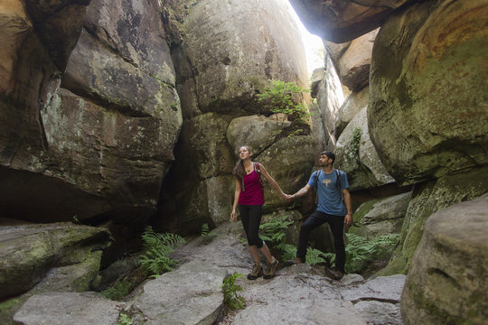 Caucasian couple exploring cave