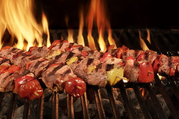 Many Shish Kebab On The BBQ Flaming Charcoal Grill