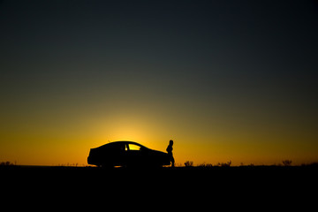 Silhouette of sedan car on the background of beautiful sunset