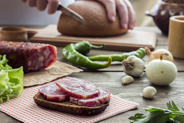 Sandwich with sausage on the kitchen table