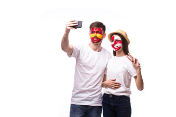 Selfie on phone of Turkey and Spain football fans in game supporting of national teams on white background. European football fans concept.