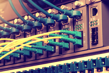 Fiber Optic cables connected to an optic ports and Network cable