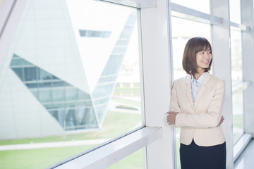 Attractive asian business woman smiling outside office