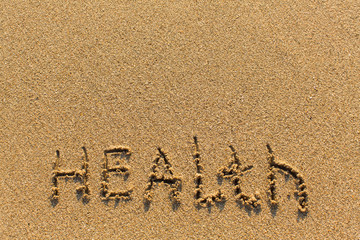 Health - drawn of the hand on the beach sand.