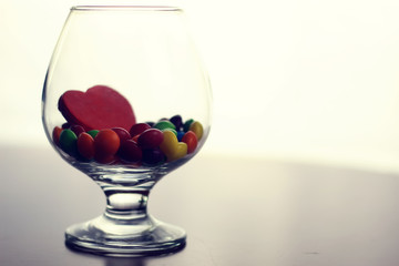 glass with candy pill