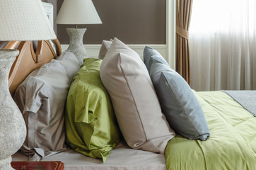 row of pillows on bed in classic bedroom
