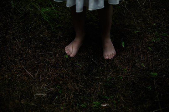 Caucasian Girl With Bare Feet In Dirt