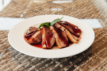 fried steak in a white plate on the table