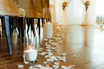 white candles in vase on the floor for ceremony