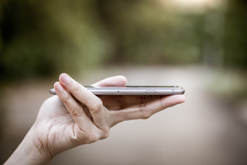 Close-up hand of asian woman using smart phone
