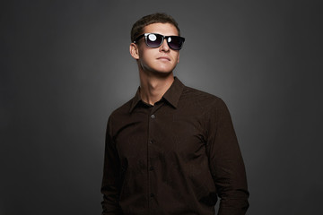 Obraz premium fashion portrait of handsome man in sunglasses.Brutal guy