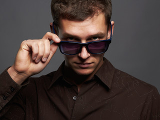 fashion portrait of handsome man in sunglasses.Brutal guy