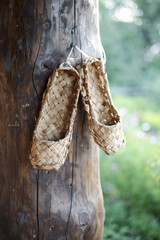 Old rustic shoes hanging on a nail