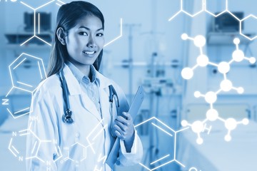 Composite image of asian doctor holding clipboard