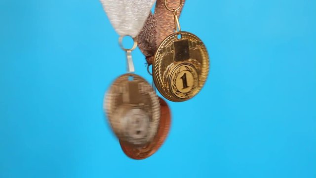 gold, silver, bronze medal on a blue background