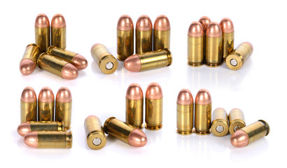 collection of cartridges of .45 ACP pistols ammo on white backgr
