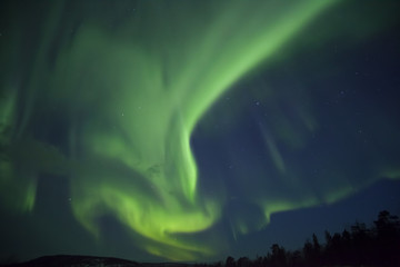 Aurora Borealis with green and purple light at Inari lake, finland, Lapland, natural spectacle at night