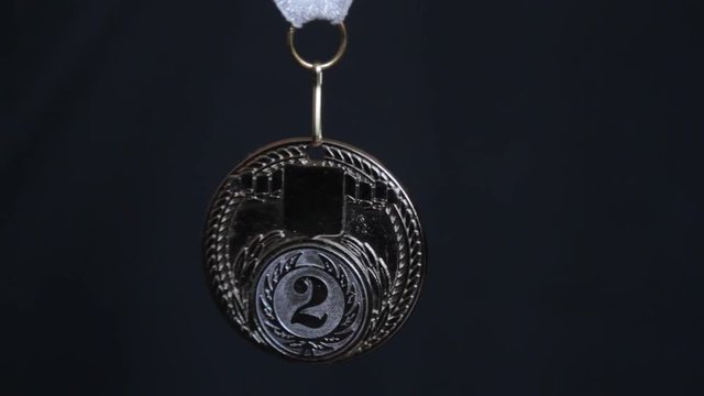 silver medal on a black background 