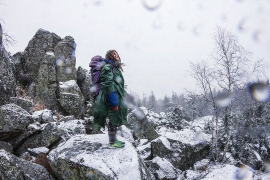 Caucasian hiker standing on rocky hillside