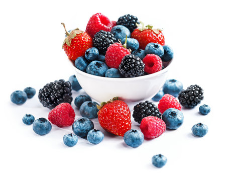 Ceramic bowl with assortment berries (blueberries, strawberries and blackberries) on white background. Close up, high resolution product. Harvest Concept